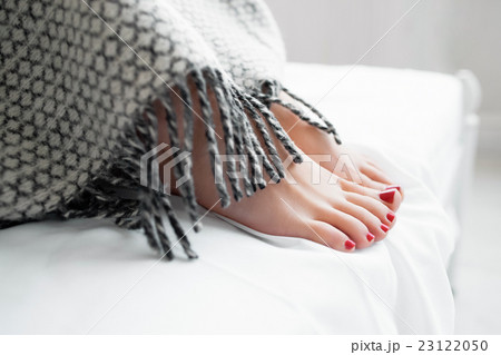 Barefoot female and male feet in socks in bed. Warm-blooded and