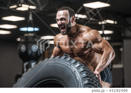 Old brutal strong bodybuilder athletic men pumping up muscles wi