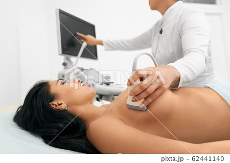 Breast screening concept. Black woman in bra rubbing her breast