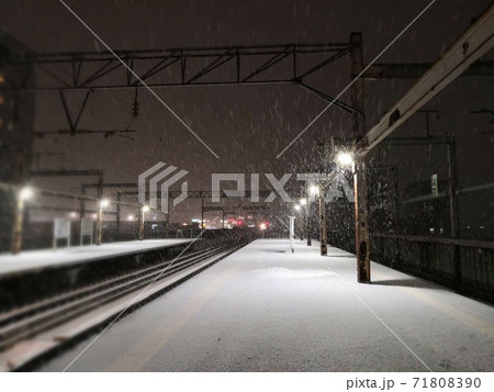 駅 電車 夜 降雪の写真素材