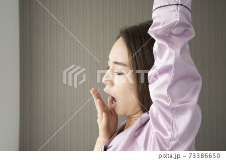 あくびをする女性/パジャマ姿の女性/寝起きの美しい女性