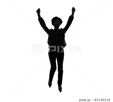 シルエット 女性 ジャンプ ガッツポーズの写真素材