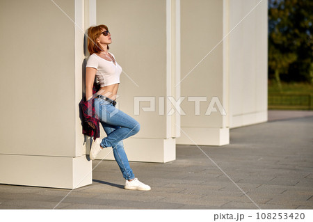 Redhead cute young hipster woman in stylish T-shirt in trendy